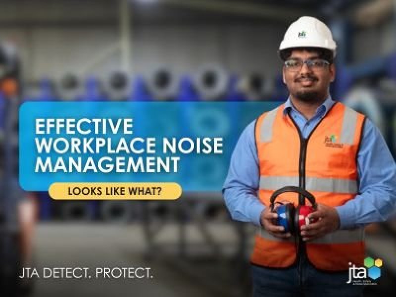 Worker wearing hearing protection in an industrial environment representing effective workplace noise management