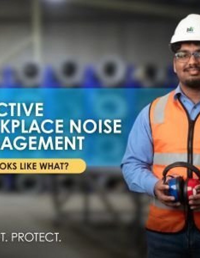 Worker wearing hearing protection in an industrial environment representing effective workplace noise management